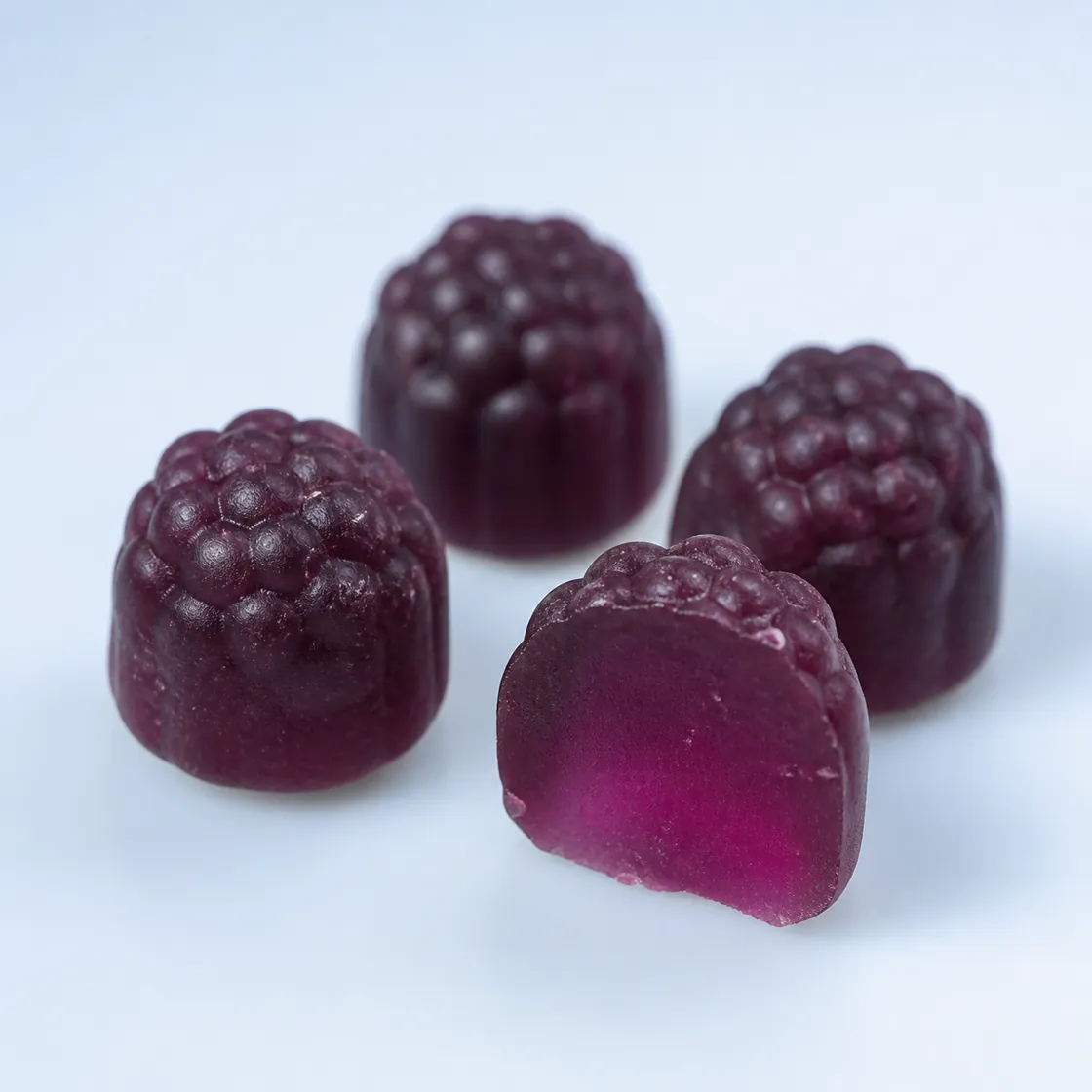 Deep-purple Wild Blueberry gummy with a translucent cutaway