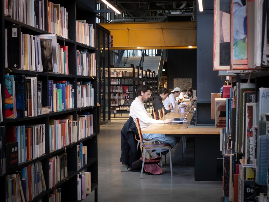 best nootropics for studying - Students studying quietly at long wooden tables inside a mod | NooBlue