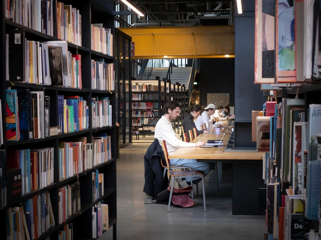 best nootropics for studying - Students studying quietly at long wooden tables inside a mod | NooBlue