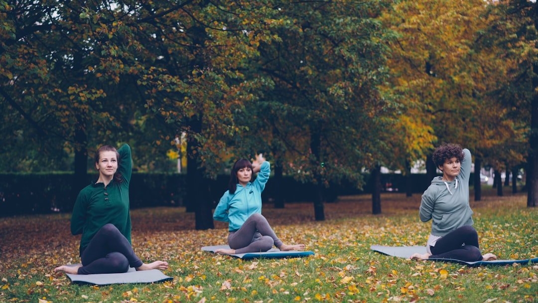 methylene blue for depression - Relaxed females are sitting on yoga mats in Cow Face pose an | NooBlue