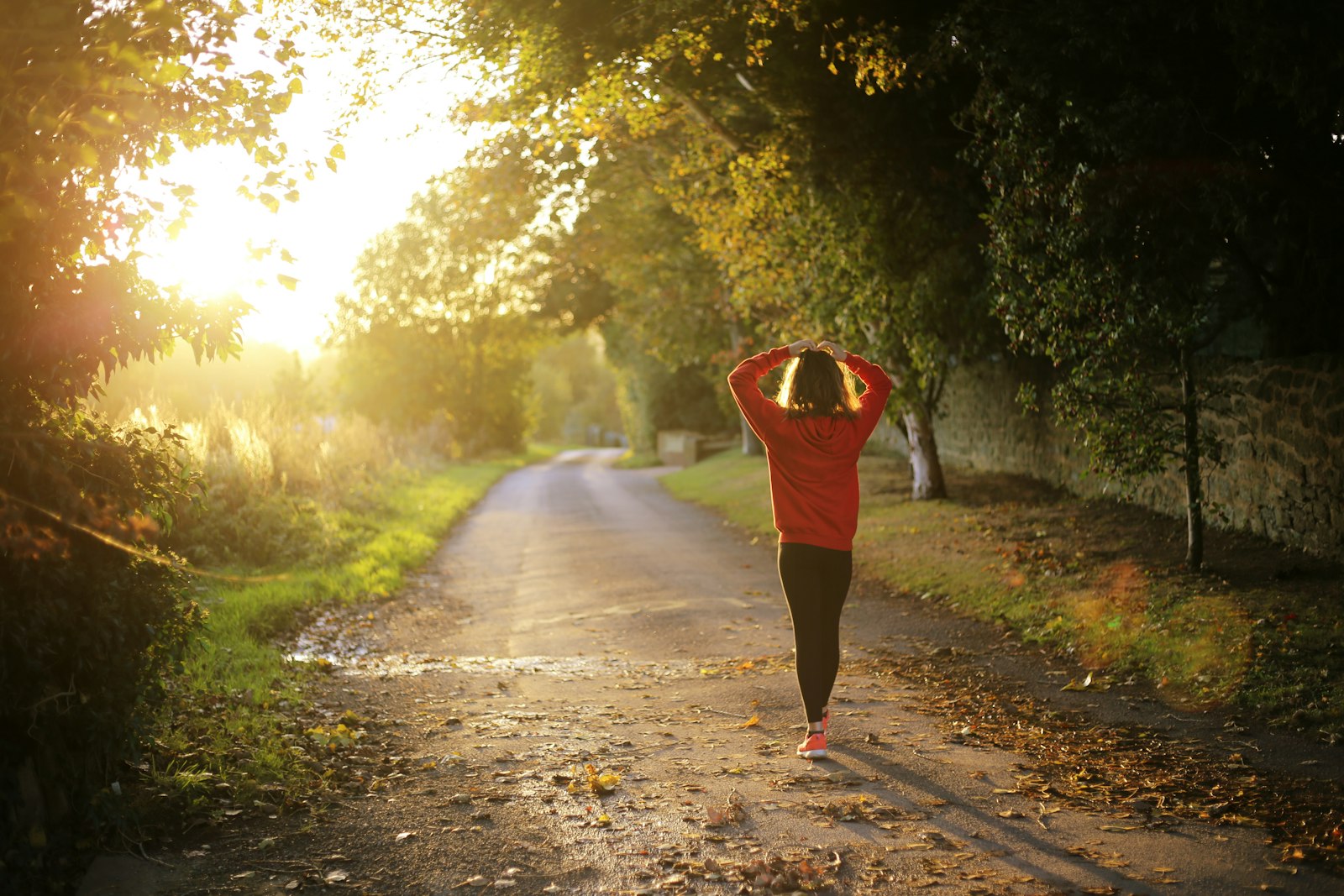 Woman walking outdoors in morning light, illustrating how to get more energy naturally