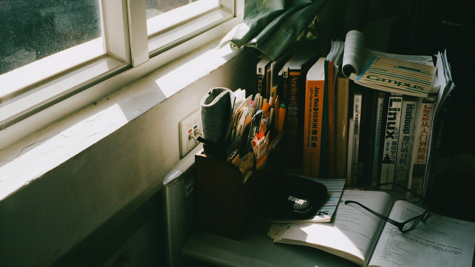 Best memory supplements guide: books and reading glasses on a sunny table by the window
