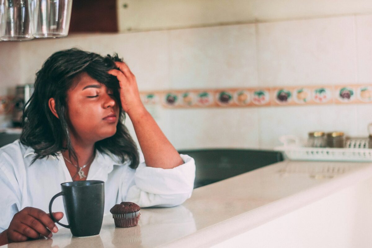 Woman feeling tired in the morning with a cup of coffee