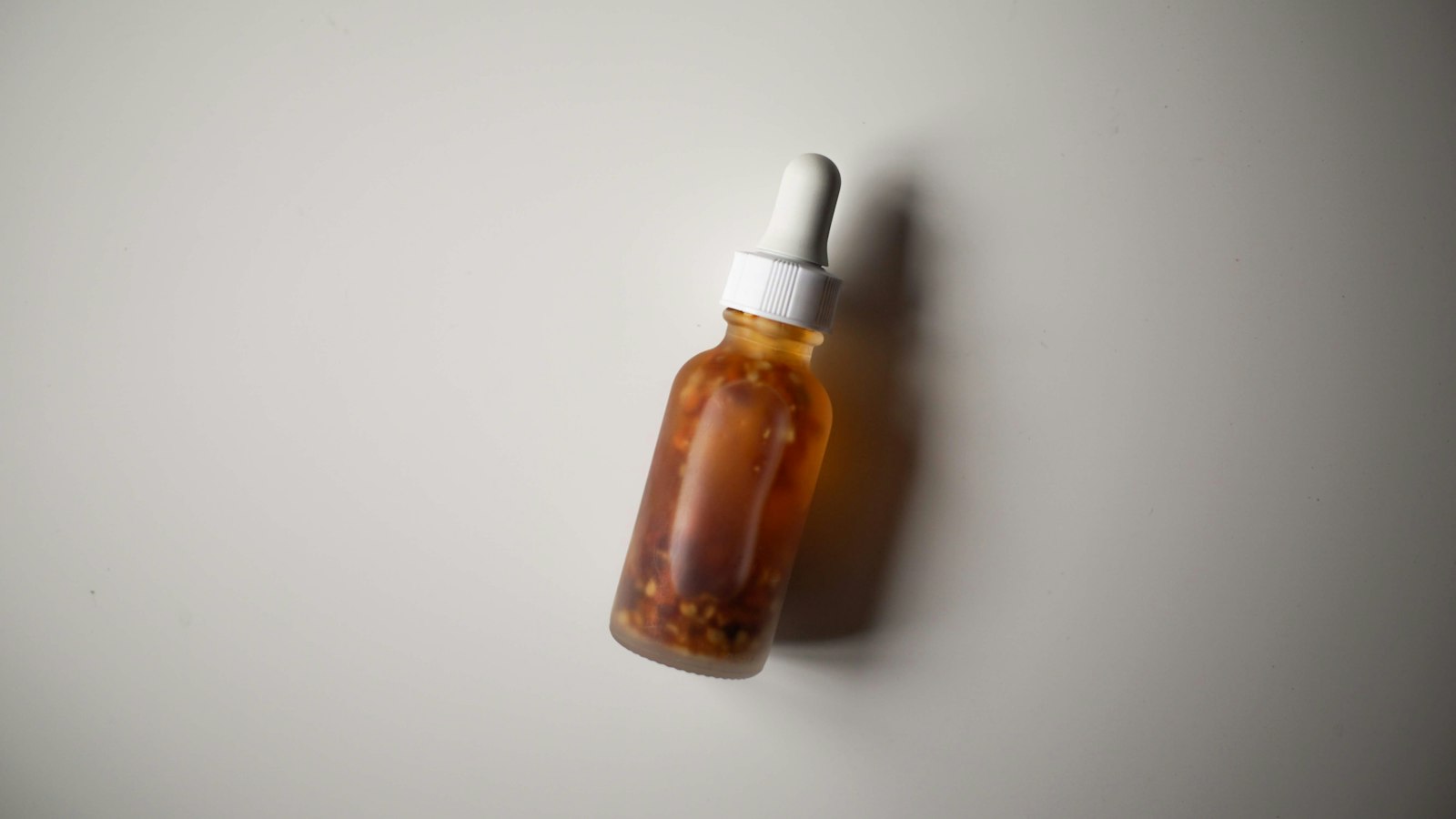 Blue liquid in a glass dropper bottle