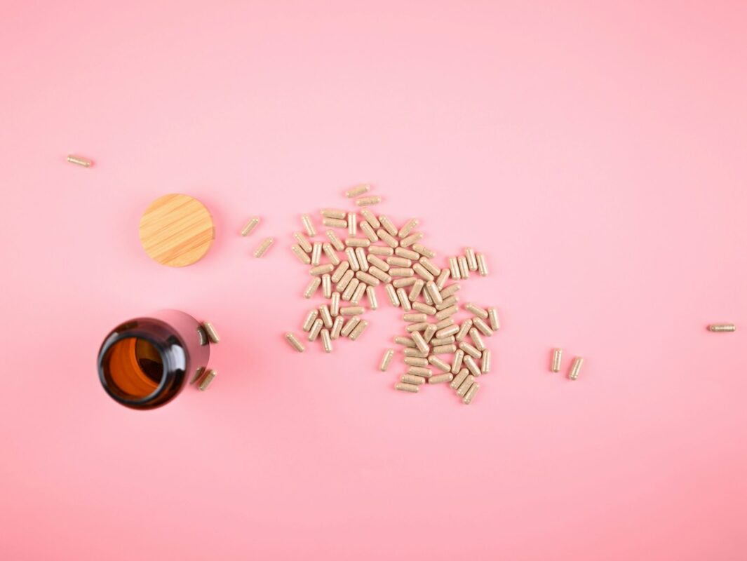 NooBlue vs Supreme methylene blue capsules spilled from a brown supplement bottle